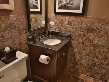 bathroom with vanity and brown accents