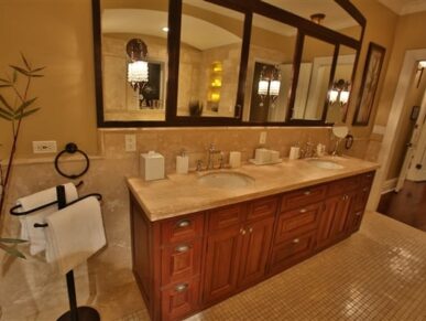 Two vanity sinks in bathroom and large mirror above